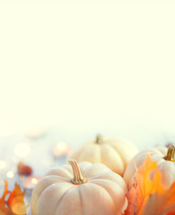 Thanksgiving background. Holiday scene. Wooden table, decorated with pumpkins, autumn leaves and...