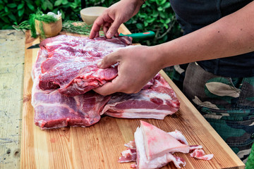 Butcher prepares meat for rolled roast pork