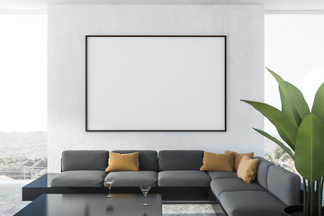 White living room, gray sofa, poster close up