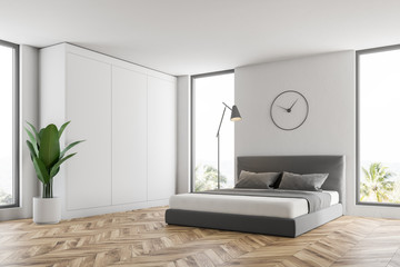 White bedroom corner with clock
