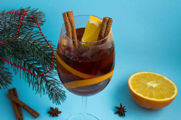 Mulled wine in the glass  on the blue  background.Closeup.