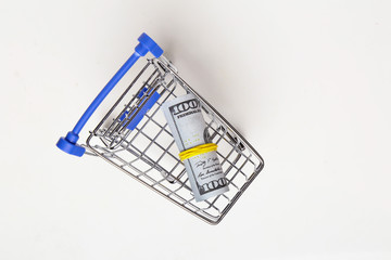 Shopping cart with dollars isolated on white background