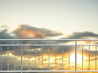 chrome fence, stainless steel fence, inox fence or alu fence. aluminum fence with sunset clouds sky background. 3D illustration