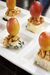 Naklejka na ściany i meble Cheese and Fruit Skewers. Perfect combination of blue cheese, pink grapes and walnuts