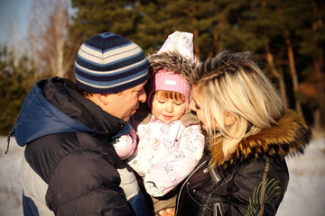 dad mom baby happy outside winter snow