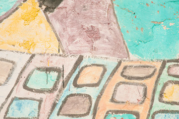 Bright colored street art. Full-color drawings on the wall. Colorful pattern close-up. Stone structure texture.