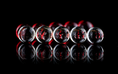 Small, round, white medicine capsules containing nitroglycerin, validol