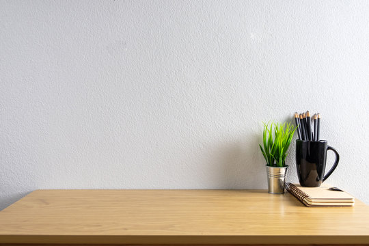 Wooden Desk Table With Copy Space, Supplies And Coffee Mug. Front View Workspace And Copy Space