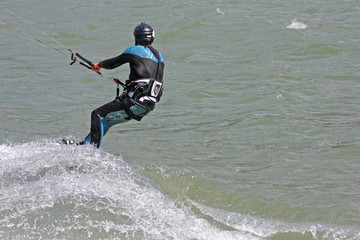 kitesurfer riding his board