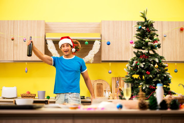 Young man celebrating Christmas in kitchen 
