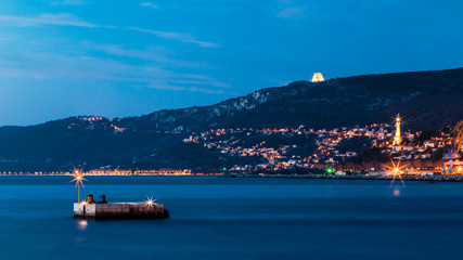 Colorful sunset in front of the city of Trieste