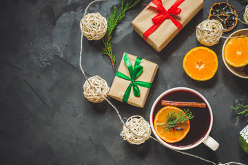 Mulled wine with spices and gifts on the table. Happy New Year! Top view