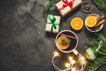 Mulled wine with spices and gifts on the table. Happy New Year! Top view