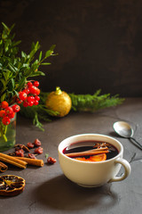 Mulled wine with spices and gifts on the table. Happy New Year! Top view
