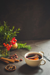 Mulled wine with spices and gifts on the table. Happy New Year! Top view