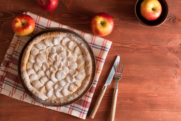 Homemade apple pie on a wooden table.