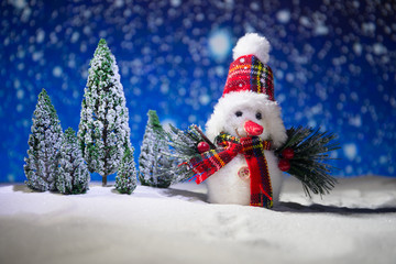 festive background. snowman dressed as Santa Claus with Christmas balls on light background photo has an empty space for your text