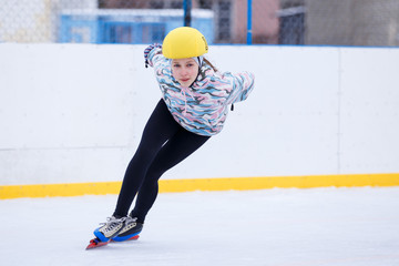 Speed skating young girl on training rink