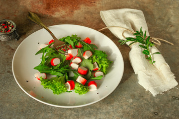 fresh salad lettuce leaves and crab sticks. top view. copy space