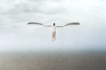 man with wings flying in the sky