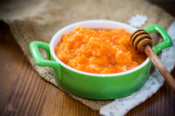 Boiled sweet pumpkin porridge with honey in a plate