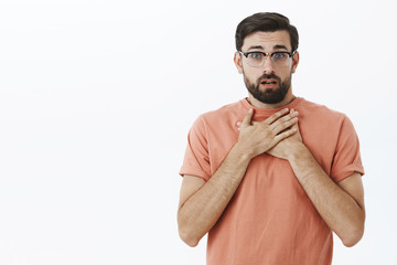 Waist-up shot of concerned charming gay friend in glasses with beard gasping from shock and empathy...