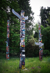 Beautiful Totem Poles among the trees in Stanley Park, Vancouver, British Columbia