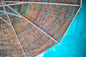 an umbrella of natural materials on a blue sky with clouds
