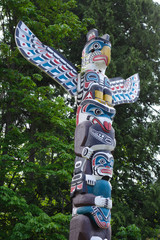 Beautiful Totem Poles among the trees in Stanley Park, Vancouver, British Columbia