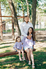 Fototapeta premium family with a little girl on nature in summer