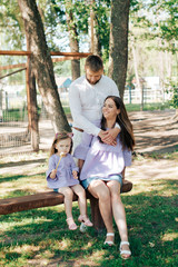 family with a little girl on nature in summer