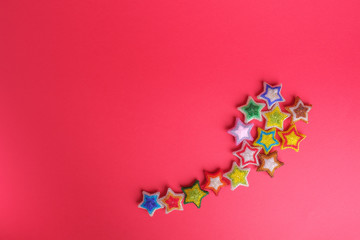 Christmas New Year star stars different colors made from beads handmade on red pink background