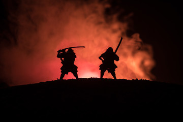 Silhouette of two samurais in duel. Picture with two samurais and sunset sky © zef art