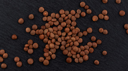 Lentils on black background. Top view