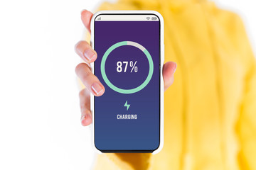 Man is holding a white generic smartphone showing the charging batter application interface.