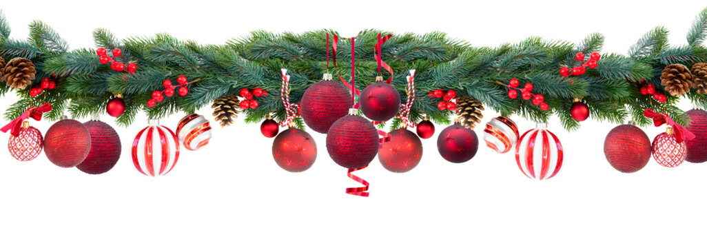 Christmas garland with red hanging balls, cones and berries on isolated white background