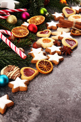 Fototapeta premium Decoration with christmas cookies. Typical cinnamon stars with fruits and nuts