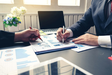 Group of business people meeting analyzing financial documents