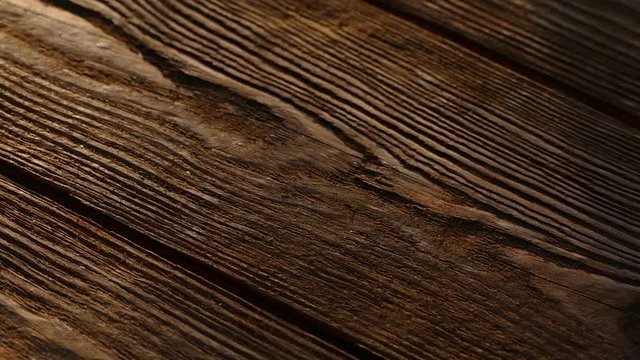 The texture of the wooden board. Old wooden table. An ancient relic. Dark background.