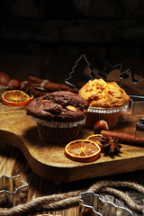 Chocolate muffin and nut muffin, homemade bakery wooden background