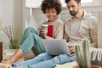 Image of family couple choose items for home in internet web store, make shopping online together,...
