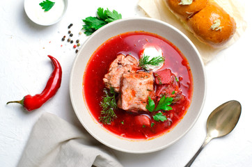 Borscht, Red Soup Made of Beetroot and Vegetables with Pork Ribs and Sour Cream Served with Garlic Rolls, Ukrainian, Russian and Polish Traditional Dish