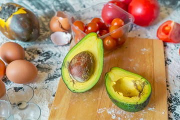 close up sliced avocado on the wooden board on table while food preparation f