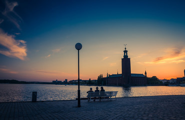 Silhouette of women sitting on bench, Stockholm City Hall, Sweden