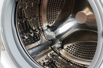 Close-up photo of empty washing machine tank.