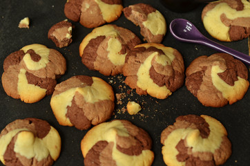 Chocolate-vanilla shortbread cookies on a black background