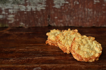 Almond cookies lying on a wooden background