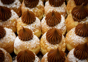 Fresh  chocolate donuts at bakery display for Hanukkah celebration. Selective focus.
