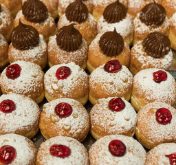 Fresh  donuts at bakery display for Hanukkah celebration. Selective focus.