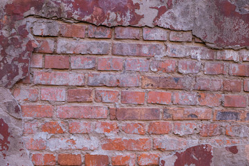 A fragment of a red brick wall at an idle factory,shot in late autumn